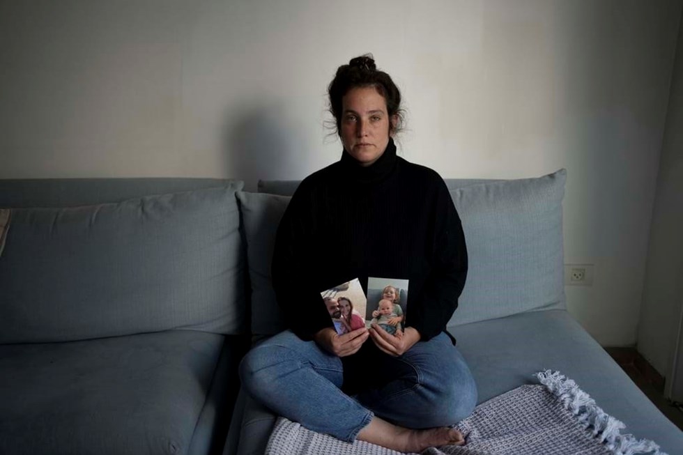 Yifat Zailer segura nas mãos sua prima Shiri Bibas, seu marido Yarden e seu filho Ariel, que está sendo mantido como refém pelo Hamas. Fotos de Ariel e Kfir.