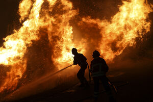 Bombeiros combatem incêndio com mangueiras