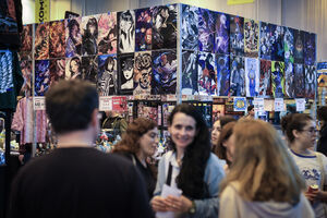 Visitantes apreciam posters e figuras de ação na Comic Con em Santa Maria da Feira.
