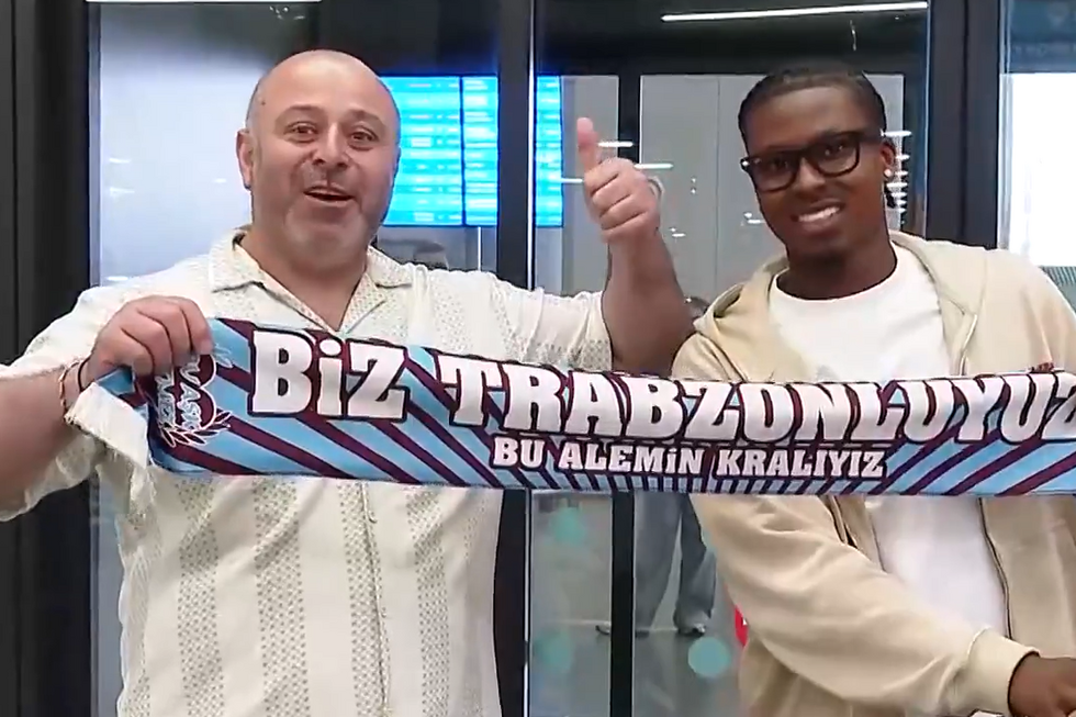 Sidny Lopes Cabral posa com cachecol do Trabzonspor junto de um adepto