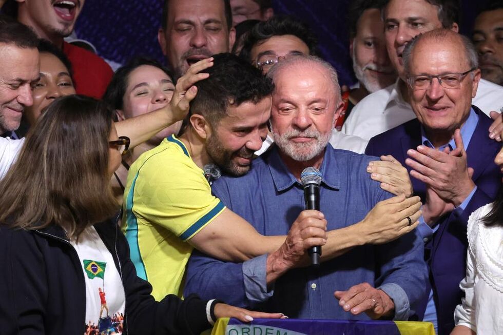 Brazilian Federal deputy Andre Janones (2-L) embraces Brazilian President Luiz